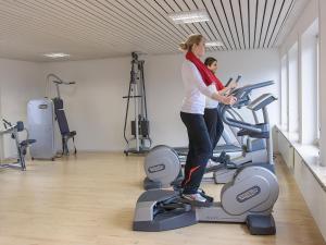 德根豪塞尔塔尔莫伦生态酒店的两个女人站在健身房的跑步机上