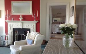 伊斯特布恩巴塞特斯别墅旅馆的客厅配有白色椅子和壁炉