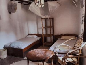 帕杰Sunny House Paje II的带两张双层床和椅子的房间
