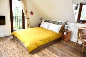 SemleyThe Roost的一间卧室配有一张黄色毯子床