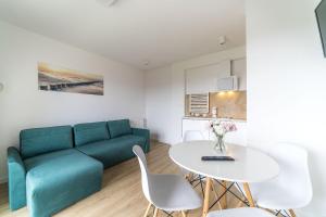 亚斯塔尔尼亚Apartamenty i Pokoje Gościnne Relax的客厅配有绿色沙发和桌子