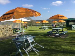 斯拉利Rose & Crown的一组野餐桌和一把伞