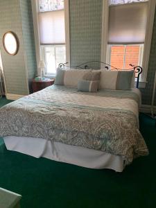 克里普尔克里克Hotel St Nicholas的卧室内的一张大床,铺有绿色地毯