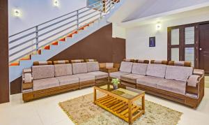 马迪凯里Treebo Trend Igloo Residency Raja Seat的客厅设有两张沙发和一个楼梯