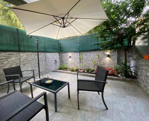 罗马Mimma’s house Monteverde的一个带桌子和遮阳伞的庭院