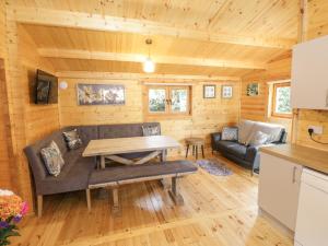 阿斯隆Port Heron Lodge的客厅配有沙发和桌子