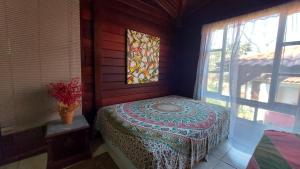 曼加拉蒂巴Eco Paradise Muriqui的带窗户的客房内的一张床
