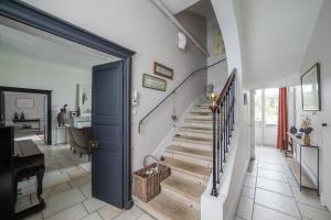 南特La Maison D'Hôtes Nantes Centre的一间房子里带蓝色门和楼梯的走廊