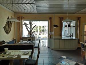 多瑙河畔诺伊施塔特Pension Martinus的厨房以及带桌椅的用餐室。