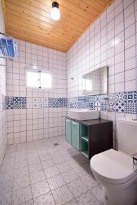 绿岛Qing Feng Diving B&B的白色瓷砖浴室设有卫生间和水槽