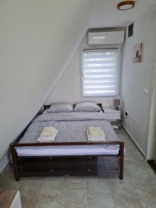 维尔蒂尼克Apartmani Radaković的卧室内的一张床铺,带窗户