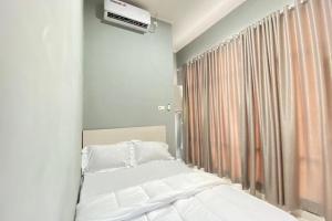 Talang KelapaPelangi Guest House Palembang RedPartner的卧室配有白色的床和窗户。