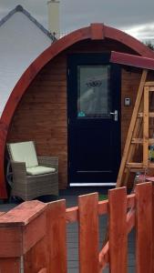 洛哈尔什教区凯尔高地Heatherbrae Cosy Wooden Pod的凉亭配有椅子和门