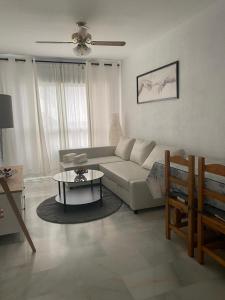 阿尔姆尼卡Velilla Park 2 Playa的客厅配有沙发和桌子