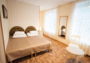 哈普萨卢苏发旅馆的一间卧室配有一张床、一张桌子和一面镜子