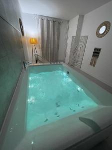 圣艾蒂安Le Châteaucreux - Cosy & SPA的客房内的蓝色浴缸