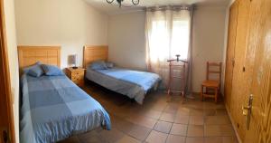 CanenciaSierra Norte的一间卧室设有两张床和窗户。