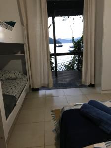 阿布拉奥Praia Comprida Flats的一间带双层床的卧室,享有海景