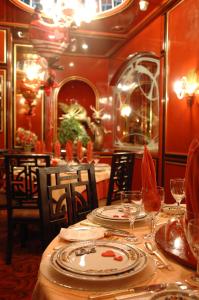 朱尼耶丽晶宫殿酒店的用餐室配有带盘子和酒杯的桌子