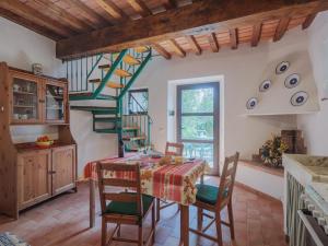 蒙蒂尼奥索Holiday Home San Remigio by Interhome的一间带桌椅的厨房和一个螺旋楼梯