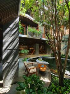 岘港Minh Boutique的一座带游泳池、长凳和树的建筑