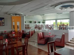 赫雷斯加西亚萨利纳斯里欧酒店的餐厅设有红色的椅子和桌椅