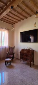 PetrignanoIl Nido del Cuculo的客厅配有大屏幕平面电视和长凳