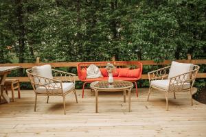 洛伊塔施Bio-Landpension Monika的庭院配有红色的沙发、两把椅子和一张桌子