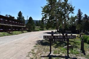 埃斯蒂斯帕克Estes Lake Lodge的一块标志,上面写着精英湖在土路上