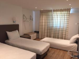 BuysinghenShelter-rooms的酒店客房设有两张床和窗户。