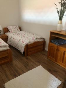 陶波尔曹Apartman Tapolca Belváros的一间卧室配有一张床和一张桌子,铺有地毯
