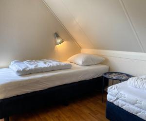 Hello Zeeland - Vakantiehuis Zwin 182客房内的一张或多张床位