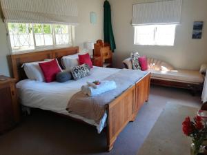 格拉罕镇AppleBee Guest Cottages的卧室配有一张带粉红色枕头的大床