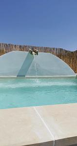 卡萨拉诺terra rossa casa di campagna con piscina的鸟坐在喷泉顶上
