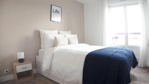 奥尔良CasaCity Orléans Sud - 2 chambres - parking privé的白色的卧室设有一张大床和一个窗户