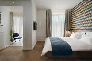 Dominic Smart & Luxury Suites - Edition客房内的一张或多张床位
