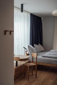 维皮泰诺Haus am Turm的卧室配有1张床、1张桌子和1把椅子