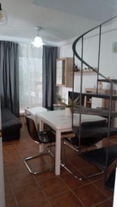 韦尔瓦ALCARAVAN 50的客厅配有白色的桌子和椅子