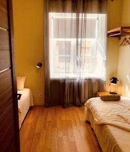 库雷萨雷Kohtu Apartment Epoch的卧室设有窗户、床和木地板