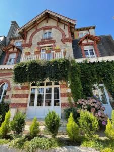 巴尼奥勒德日洛恩Le Grand Chalet的一座常春藤的大砖房子