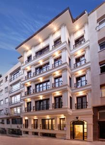 伊斯坦布尔Etiz Hotels & Residences的大型白色建筑,设有窗户和阳台