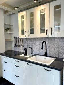 萨沃纳COZY LOFT MARINA VIEW的厨房配有白色橱柜和水槽
