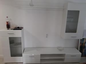 海德Ferienhaus Heide Zentrum的白色的厨房配有白色的柜台和橱柜