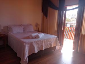 蒂拉登特斯Residencia Sao Miguel的一间卧室配有一张床,上面有两条毛巾