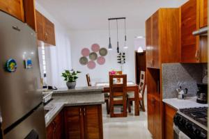 圣地亚哥洛斯卡巴Hermoso apartamento, 3 Habitaciones espaciosas, 2 Aires acondicionados的厨房配有不锈钢冰箱和桌子