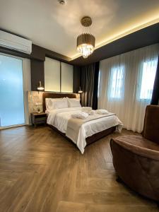 韦里亚FILEO ELEGANT LIVING的一间卧室配有一张大床和一个吊灯。