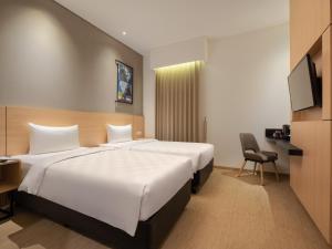 Hotel 88 Blok M Jakarta By WH客房内的一张或多张床位