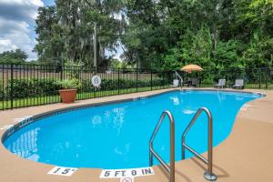德兰Comfort Inn & Suites DeLand - near University的围栏前的大型蓝色游泳池