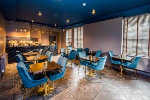 哈德斯菲尔德Stay Hotel的一间设有蓝色桌椅和柜台的餐厅