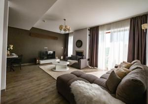 波亚纳布拉索夫Apartament lux Poiana Brasov B23的客厅配有沙发和桌子